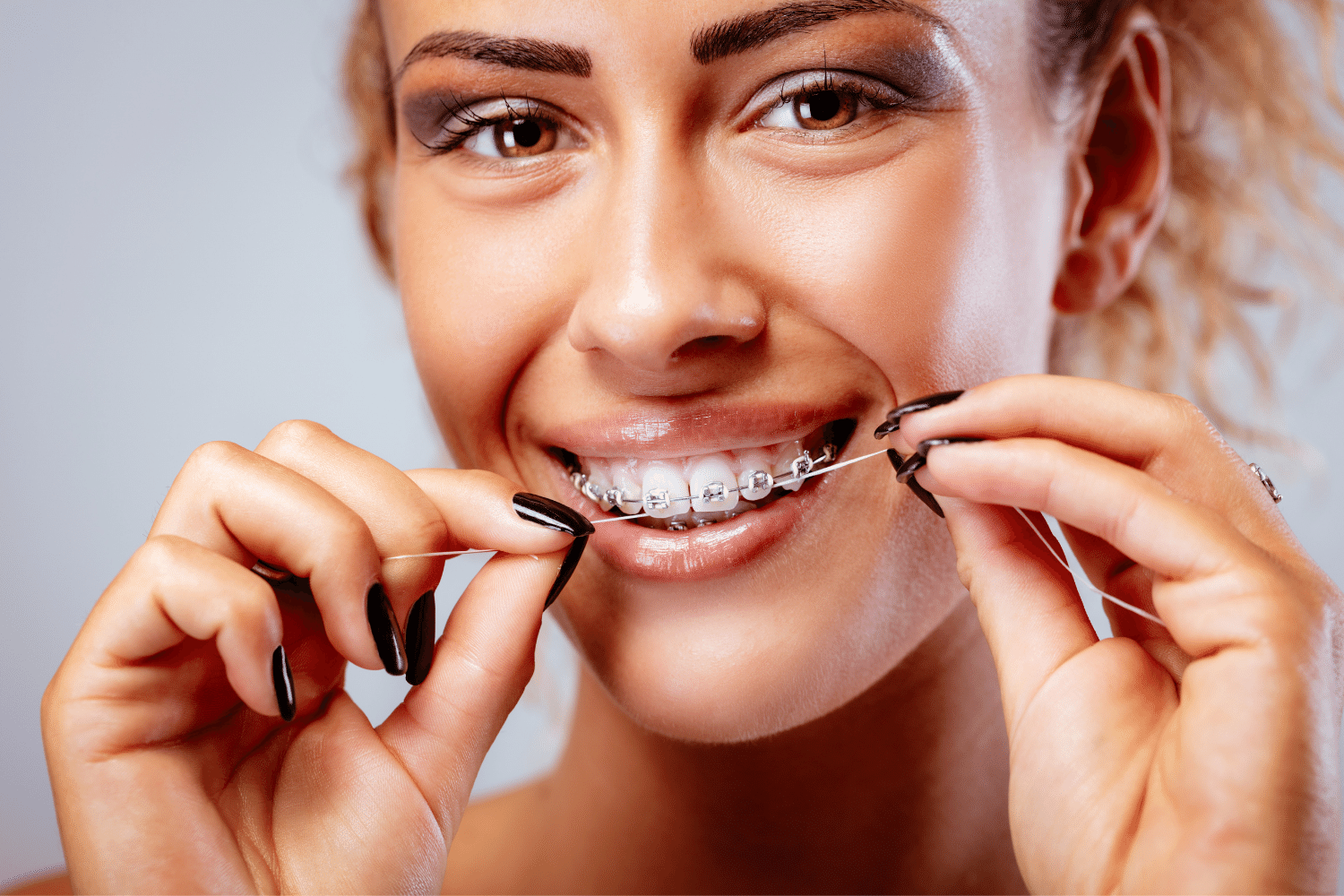 Flossing orthodontic devices